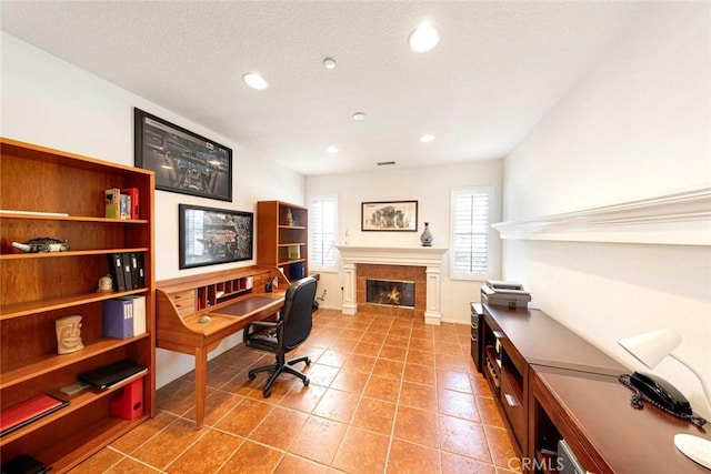 office featuring recessed lighting, tile patterned flooring, baseboards, and a tile fireplace