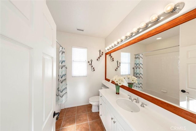 full bath featuring toilet, vanity, baseboards, visible vents, and tile patterned floors