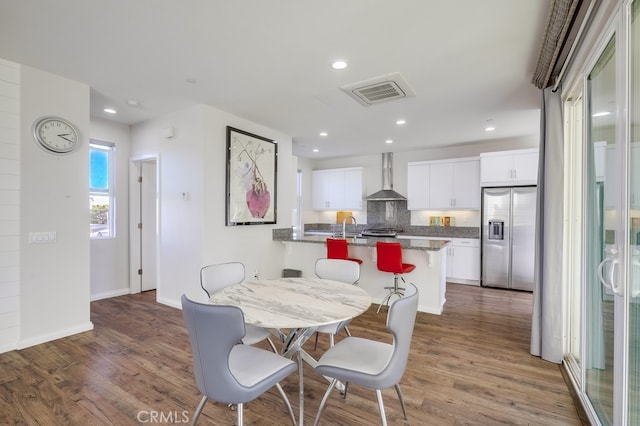 dining space with recessed lighting, dark wood-style flooring, visible vents, and baseboards