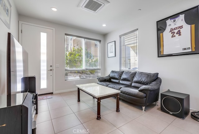 living area with recessed lighting, visible vents, baseboards, and light tile patterned floors