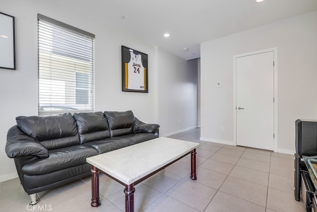 living area featuring light tile patterned floors, baseboards, and recessed lighting