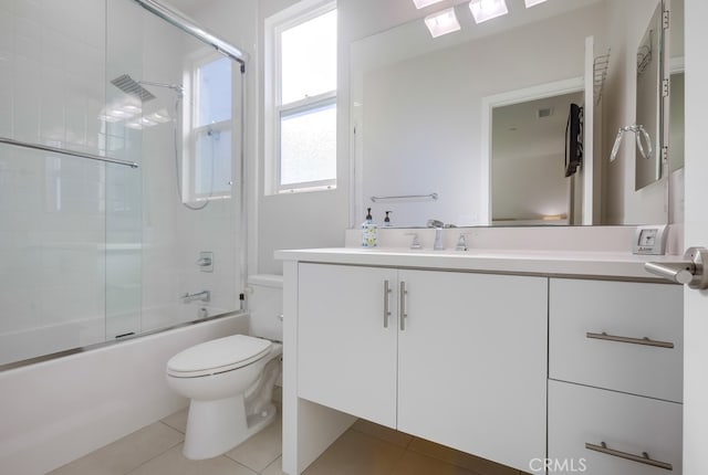 bathroom featuring toilet, shower / bath combination with glass door, tile patterned flooring, and vanity