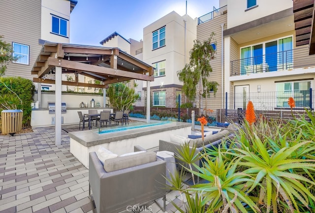 view of patio / terrace with an outdoor kitchen, an outdoor hangout area, fence, a gazebo, and grilling area