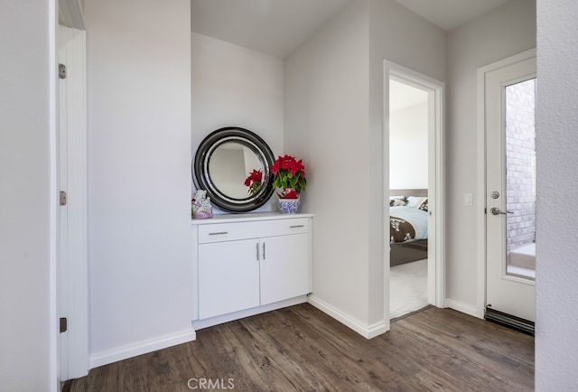 interior space with vanity, baseboards, and wood finished floors