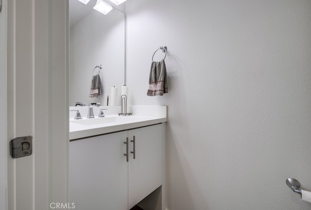 bathroom featuring a skylight and vanity