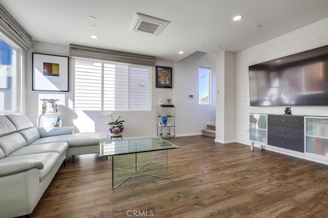 living area with recessed lighting, visible vents, baseboards, stairs, and dark wood-style floors