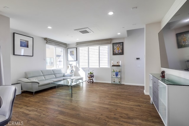 living area featuring visible vents, baseboards, dark wood finished floors, and recessed lighting