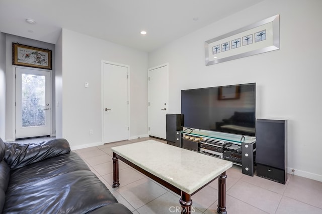 living room featuring recessed lighting, baseboards, and light tile patterned floors