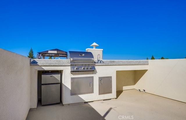 view of patio featuring a gazebo and area for grilling