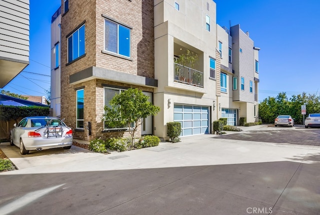 view of building exterior featuring driveway and an attached garage