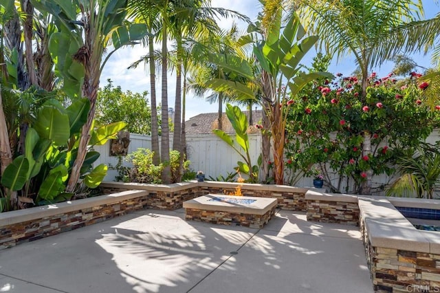 view of patio featuring an outdoor fire pit and a fenced backyard