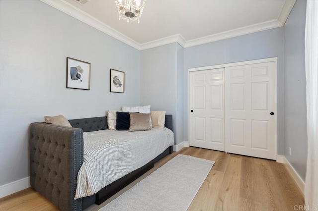 bedroom with light wood-type flooring, baseboards, and ornamental molding