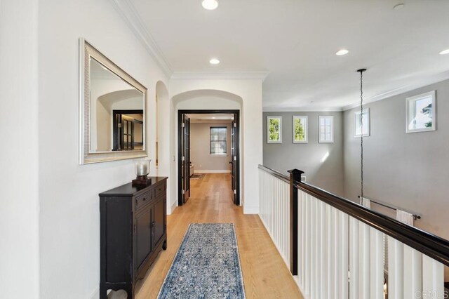 hallway with ornamental molding, recessed lighting, light wood-style flooring, and baseboards