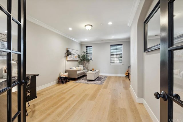 sitting room with baseboards, ornamental molding, wood finished floors, and recessed lighting