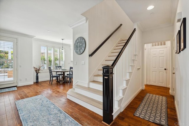 entrance foyer featuring ornamental molding, stairs, baseboards, and wood finished floors