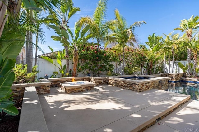 view of patio / terrace featuring an outdoor fire pit and a fenced backyard