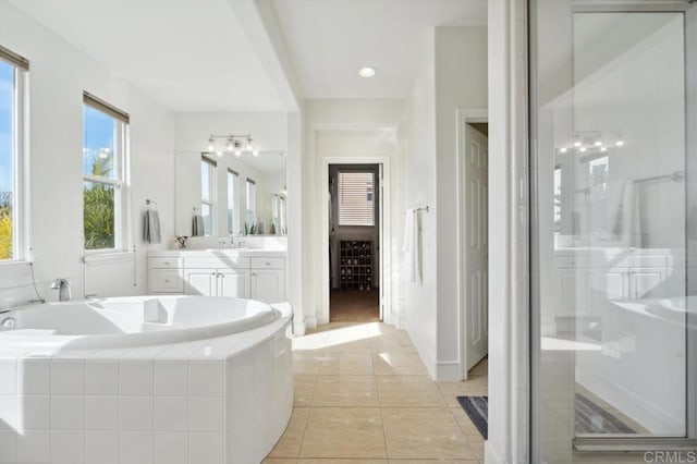 bathroom featuring tile patterned flooring, a shower stall, vanity, and a bath