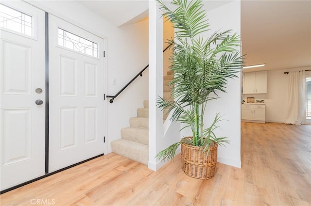 entrance foyer featuring light wood-style floors and stairway