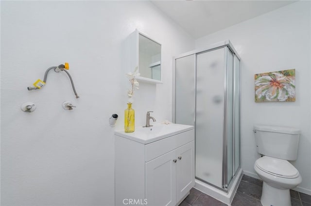 full bath with a stall shower, vanity, toilet, and tile patterned floors