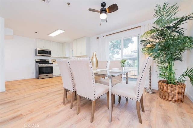 dining room featuring ceiling fan and light wood finished floors