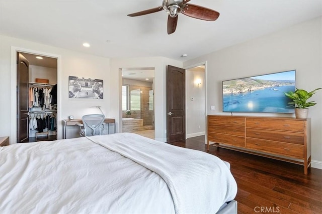 bedroom featuring baseboards, connected bathroom, dark wood-style floors, a spacious closet, and recessed lighting