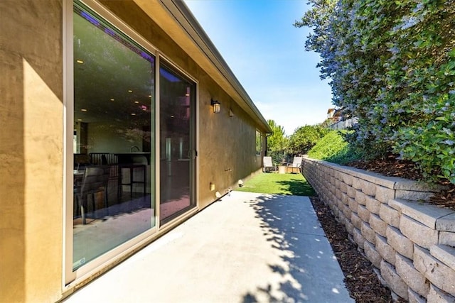 view of home's exterior with a patio and stucco siding