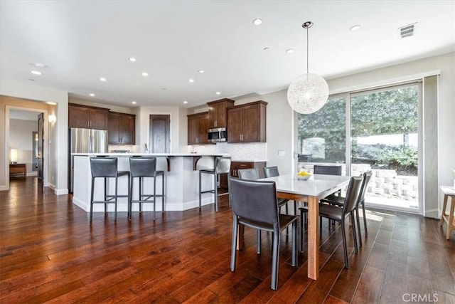 dining area featuring dark wood-style floors, visible vents, baseboards, and recessed lighting