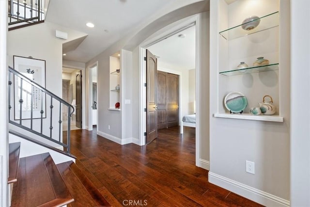 entryway with dark wood-style floors, recessed lighting, stairway, and baseboards