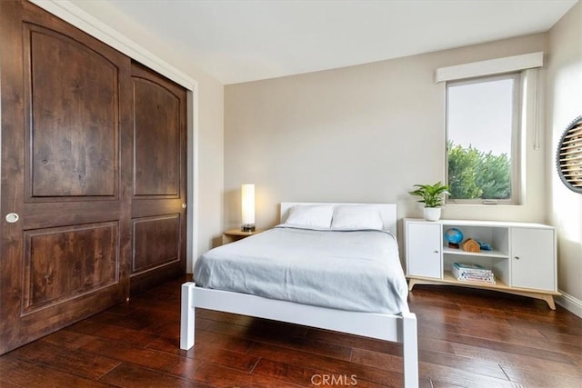 bedroom featuring dark wood finished floors