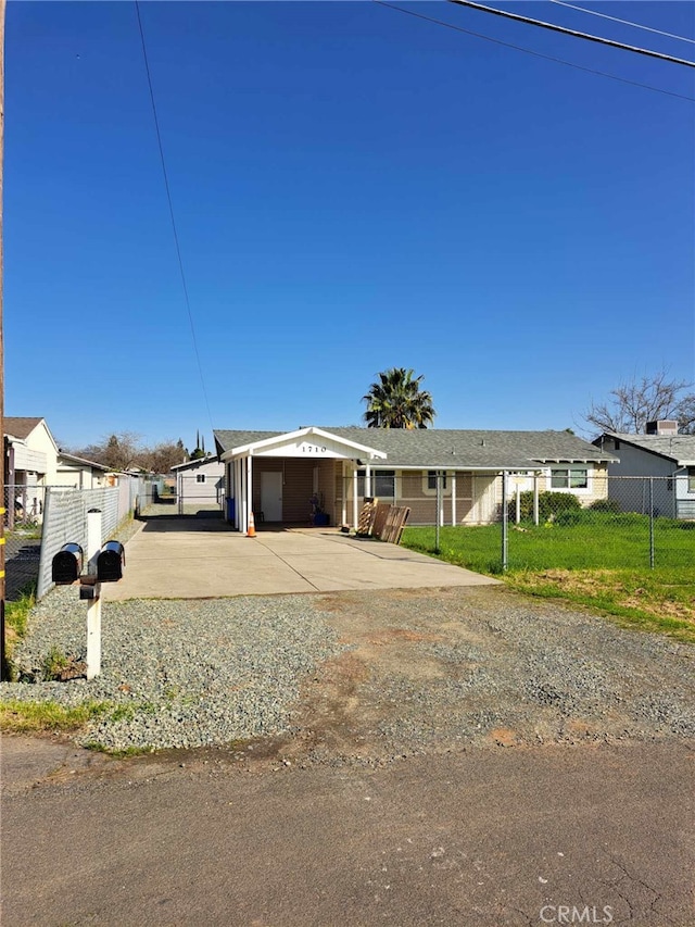 view of front of property with a garage, concrete driveway, fence, and a front lawn