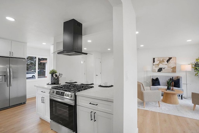 kitchen featuring stainless steel appliances, white cabinetry, light wood finished floors, and island range hood