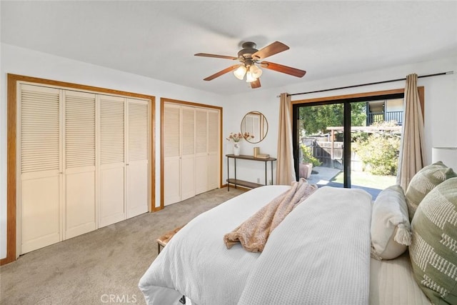 bedroom featuring light carpet, access to outside, a ceiling fan, and multiple closets