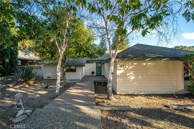 single story home with roof with shingles