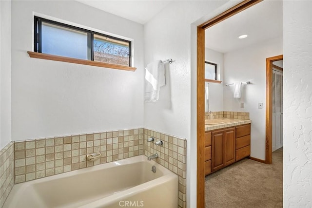 full bathroom featuring a bath and vanity