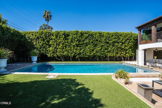 view of swimming pool with a patio, a yard, a fenced backyard, and a fenced in pool