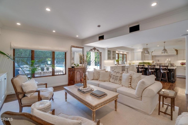 living room featuring recessed lighting, dark wood-style floors, and crown molding