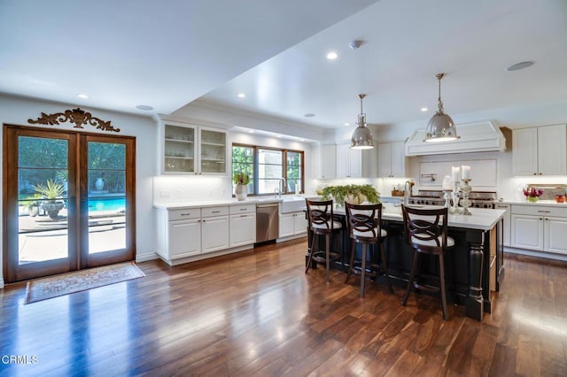 kitchen featuring dishwasher, light countertops, and white cabinetry