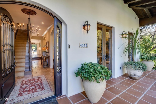 property entrance with french doors and stucco siding