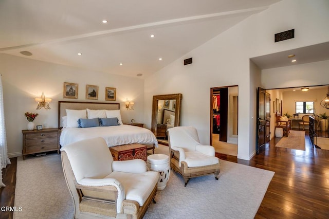 bedroom featuring high vaulted ceiling, recessed lighting, a spacious closet, and wood finished floors