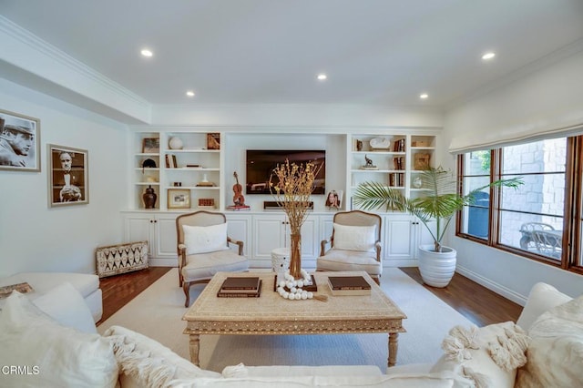 living room with crown molding, built in features, recessed lighting, and wood finished floors