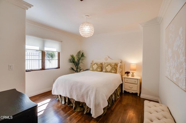 bedroom with dark wood-type flooring, ornamental molding, and baseboards