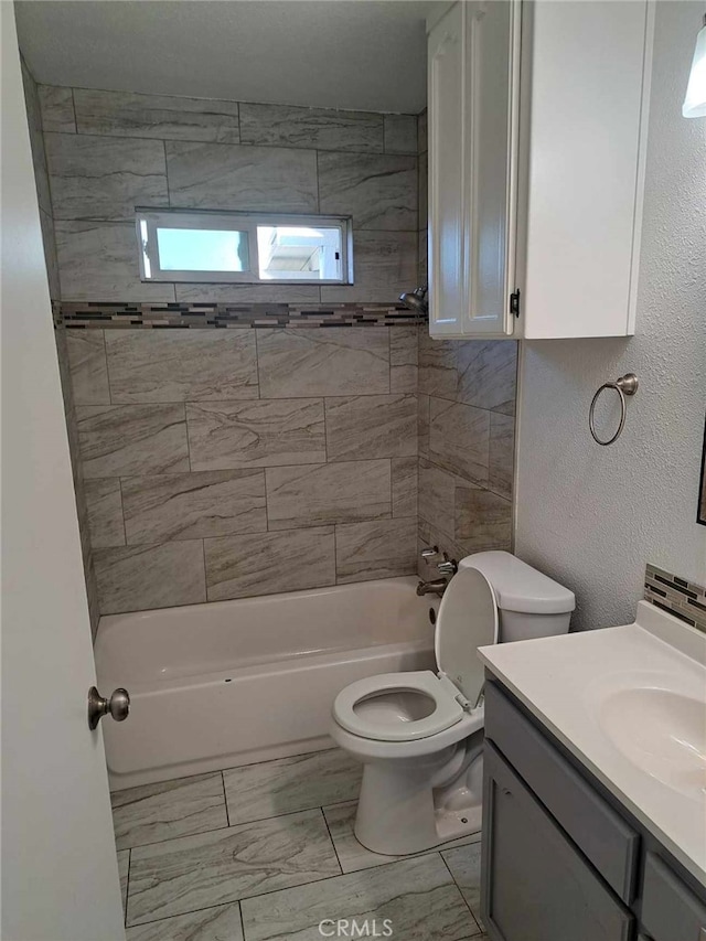 bathroom with a textured wall, toilet, shower / bath combination, vanity, and marble finish floor