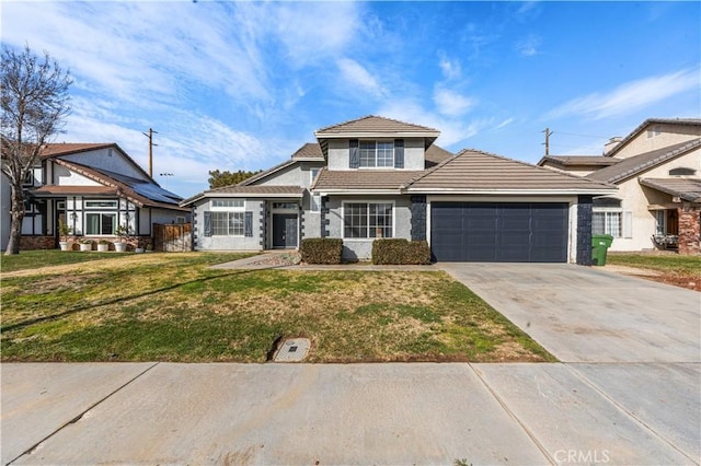 view of front of home featuring a garage, a front yard, a tile roof, and driveway