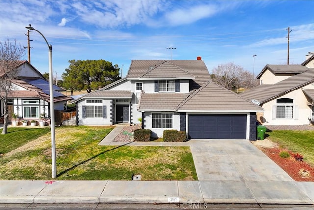 view of front of house with fence, a garage, driveway, a tiled roof, and a front lawn