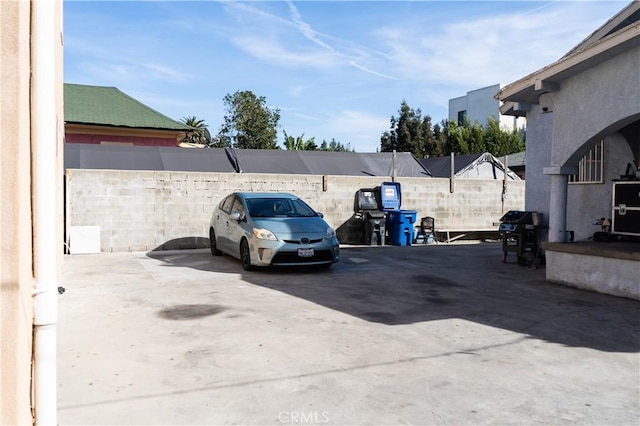 view of car parking featuring fence