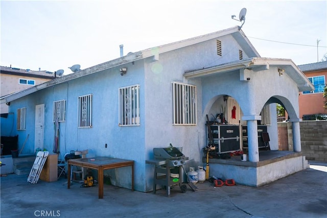 back of property featuring stucco siding