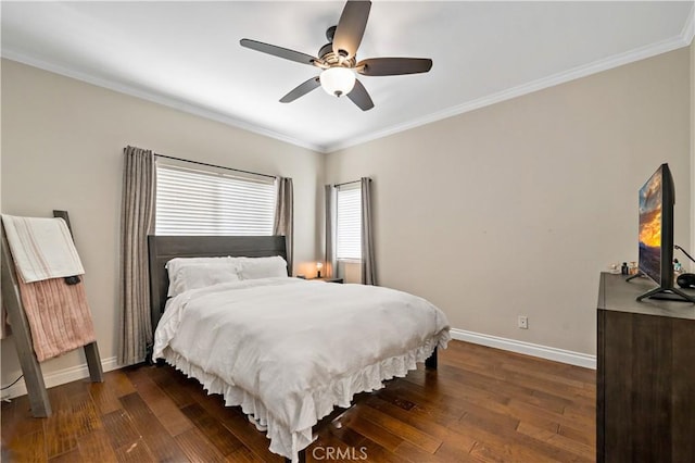 bedroom with ornamental molding, dark wood finished floors, a ceiling fan, and baseboards