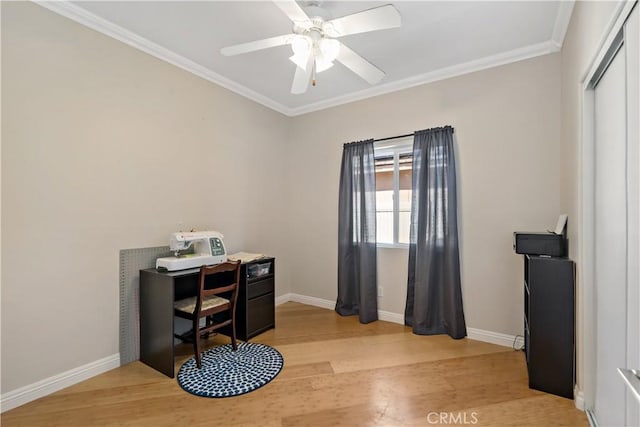 office area with light wood-type flooring, ceiling fan, baseboards, and crown molding