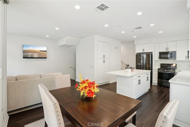 dining space featuring dark wood-type flooring, recessed lighting, and visible vents