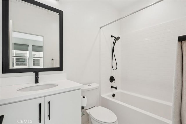 bathroom with toilet, vanity, and washtub / shower combination